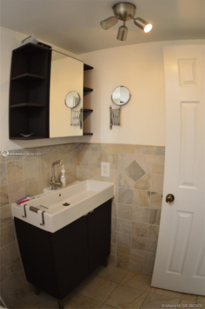 13700 Southwest 62nd Street, Unit 149 Miami, FL 33183 - Photo 28 of 36 a bathroom with a sink and a mirror