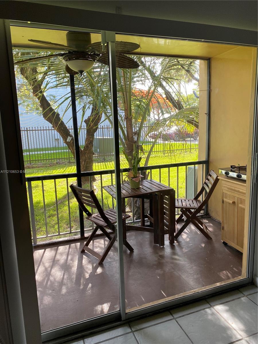 13700 Southwest 62nd Street, Unit 149 Miami, FL 33183 - Photo 30 of 36 a view of a living room with furniture and floor to ceiling window