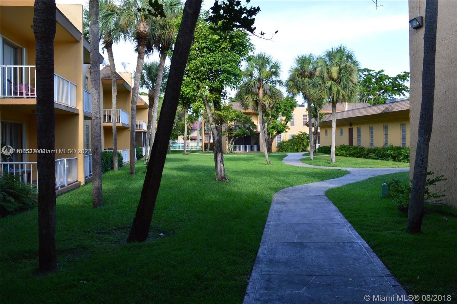 13700 Southwest 62nd Street, Unit 149 Miami, FL 33183 - Photo 32 of 36 a backyard of a house with lots of green space