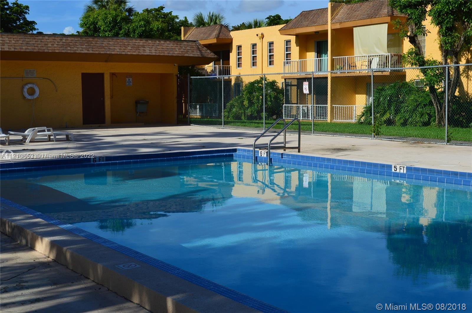 13700 Southwest 62nd Street, Unit 149 Miami, FL 33183 - Photo 35 of 36 a swimming pool with outdoor seating and yard