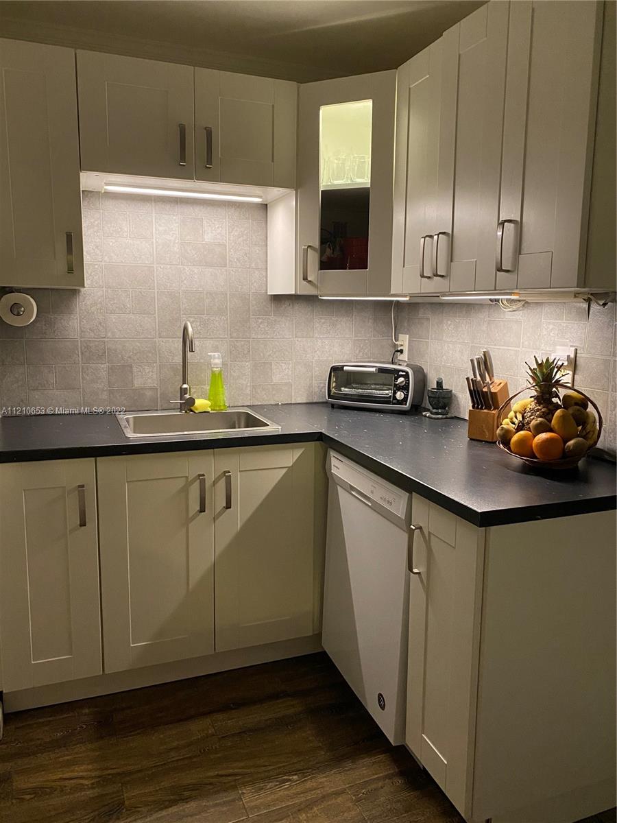 13700 Southwest 62nd Street, Unit 149 Miami, FL 33183 - Photo 10 of 36 a kitchen with stainless steel appliances granite countertop a sink a stove and cabinets