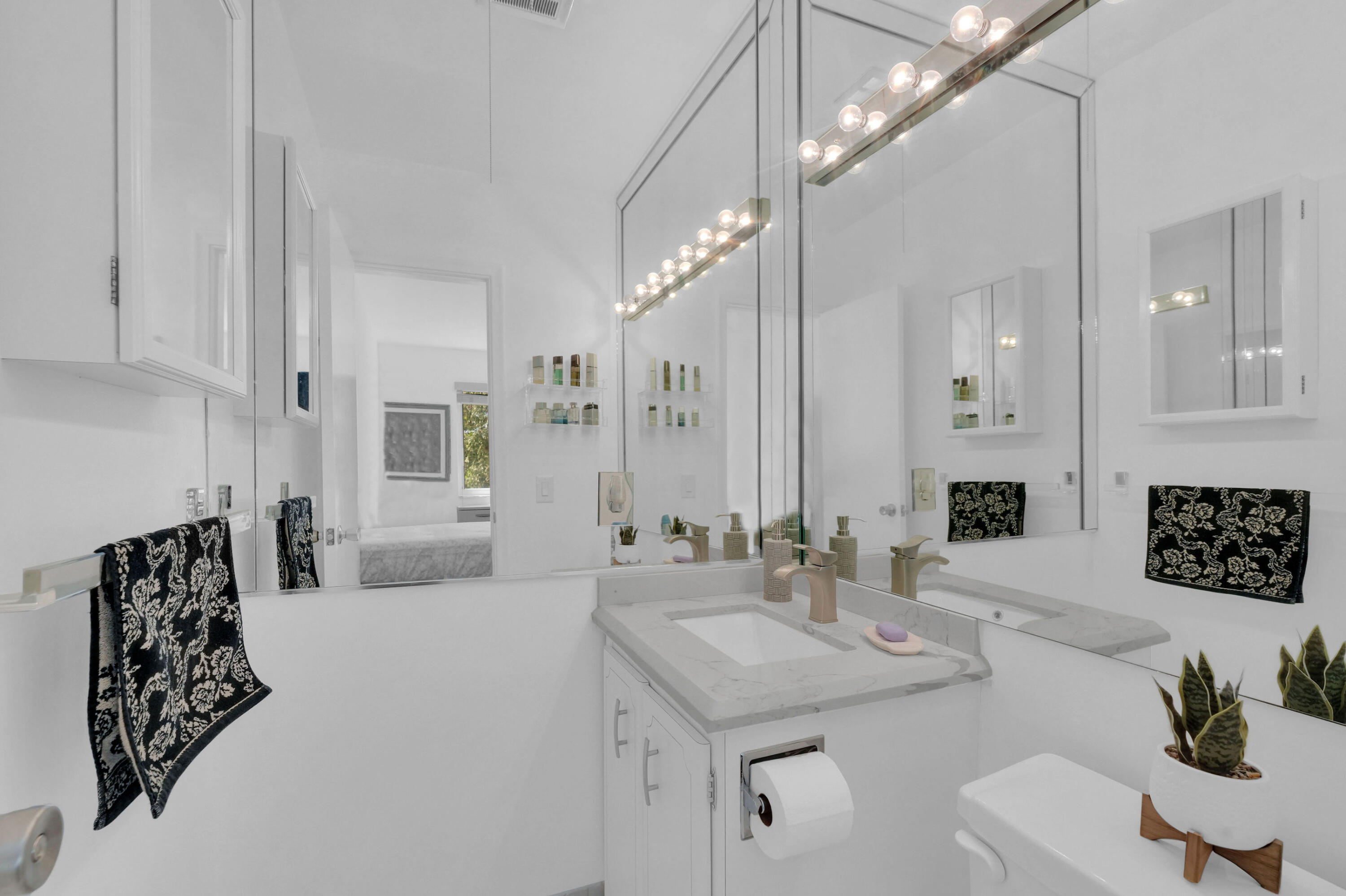 406 South Cypress Road, Unit 330 Pompano Beach, FL 33060 - Photo 16 of 38 a spacious bathroom with a double vanity sink and a mirror