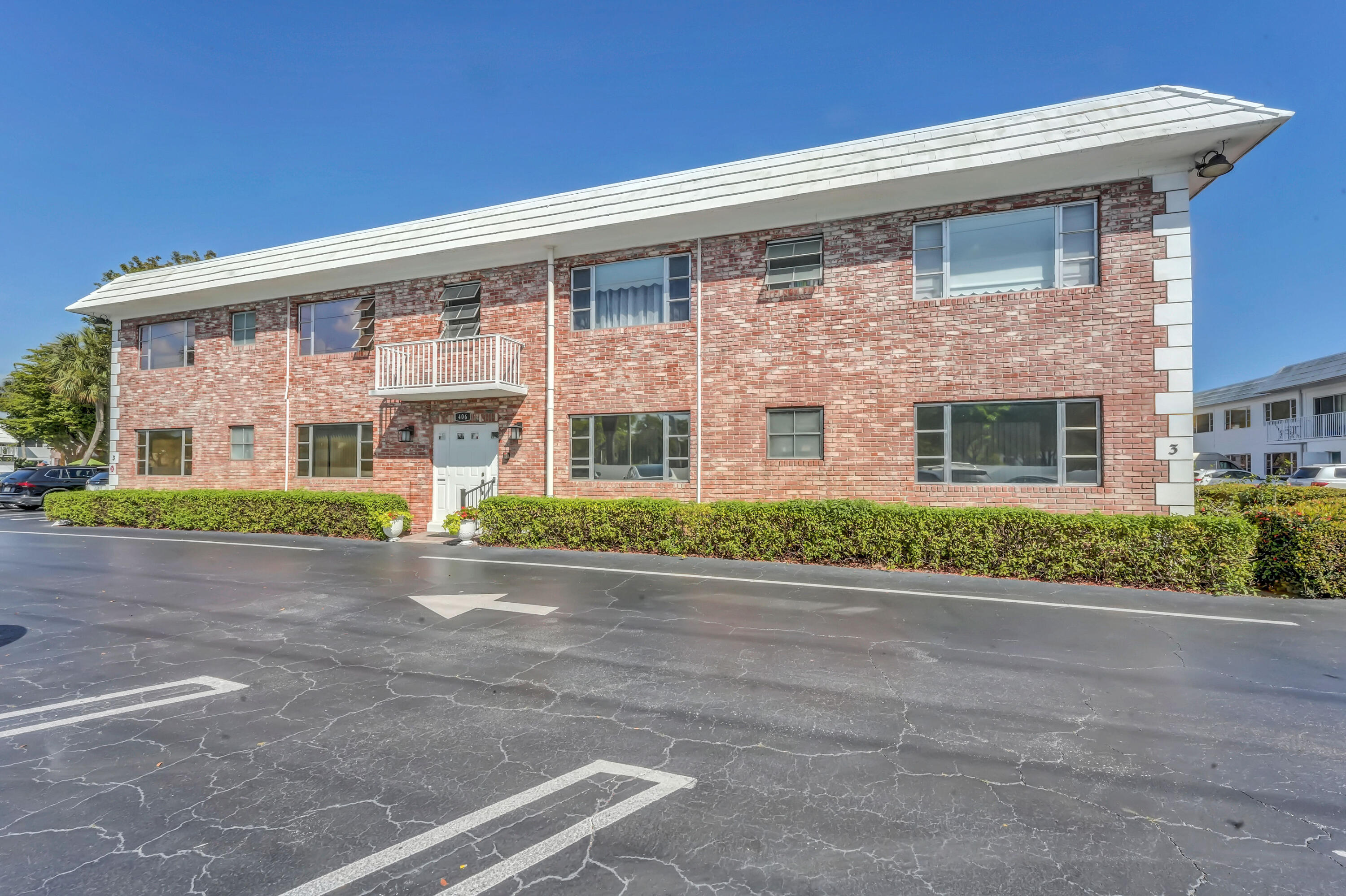 406 South Cypress Road, Unit 330 Pompano Beach, FL 33060 - Photo 2 of 38 front view of a brick house with a yard
