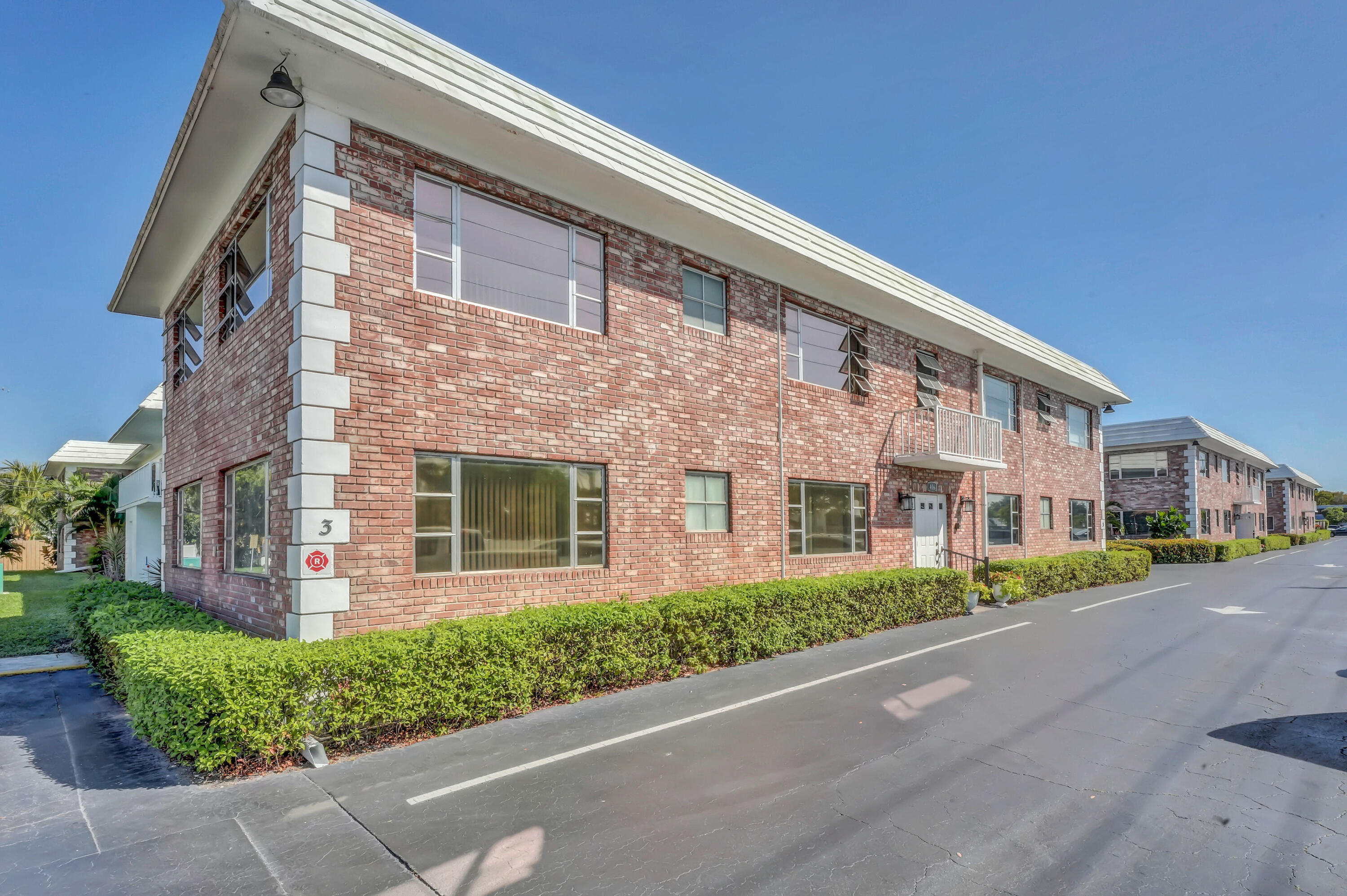 406 South Cypress Road, Unit 330 Pompano Beach, FL 33060 - Photo 26 of 38 a front view of a building with garden