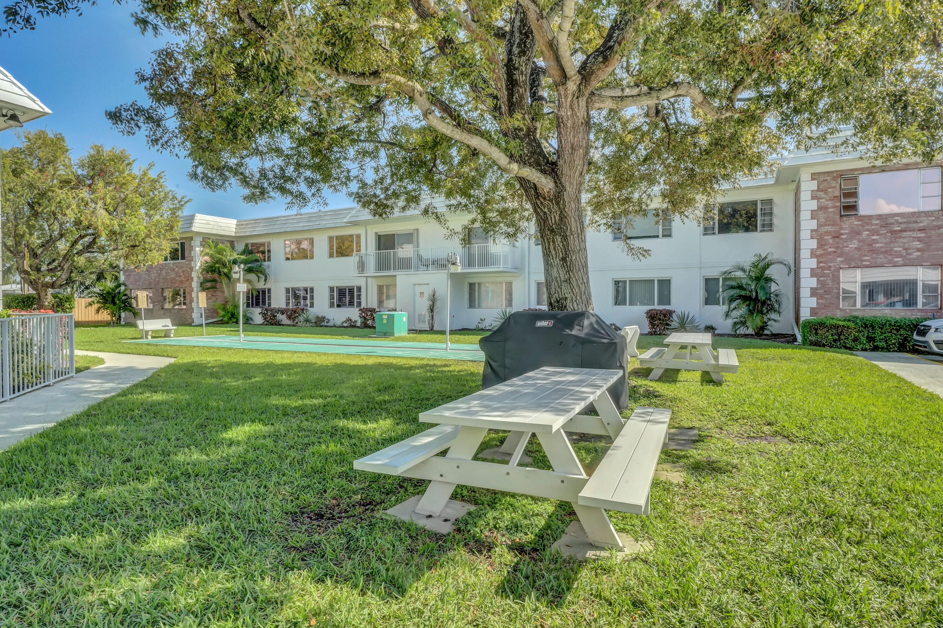 406 South Cypress Road, Unit 330 Pompano Beach, FL 33060 - Photo 33 of 38 a view of a house with a yard patio and fire pit