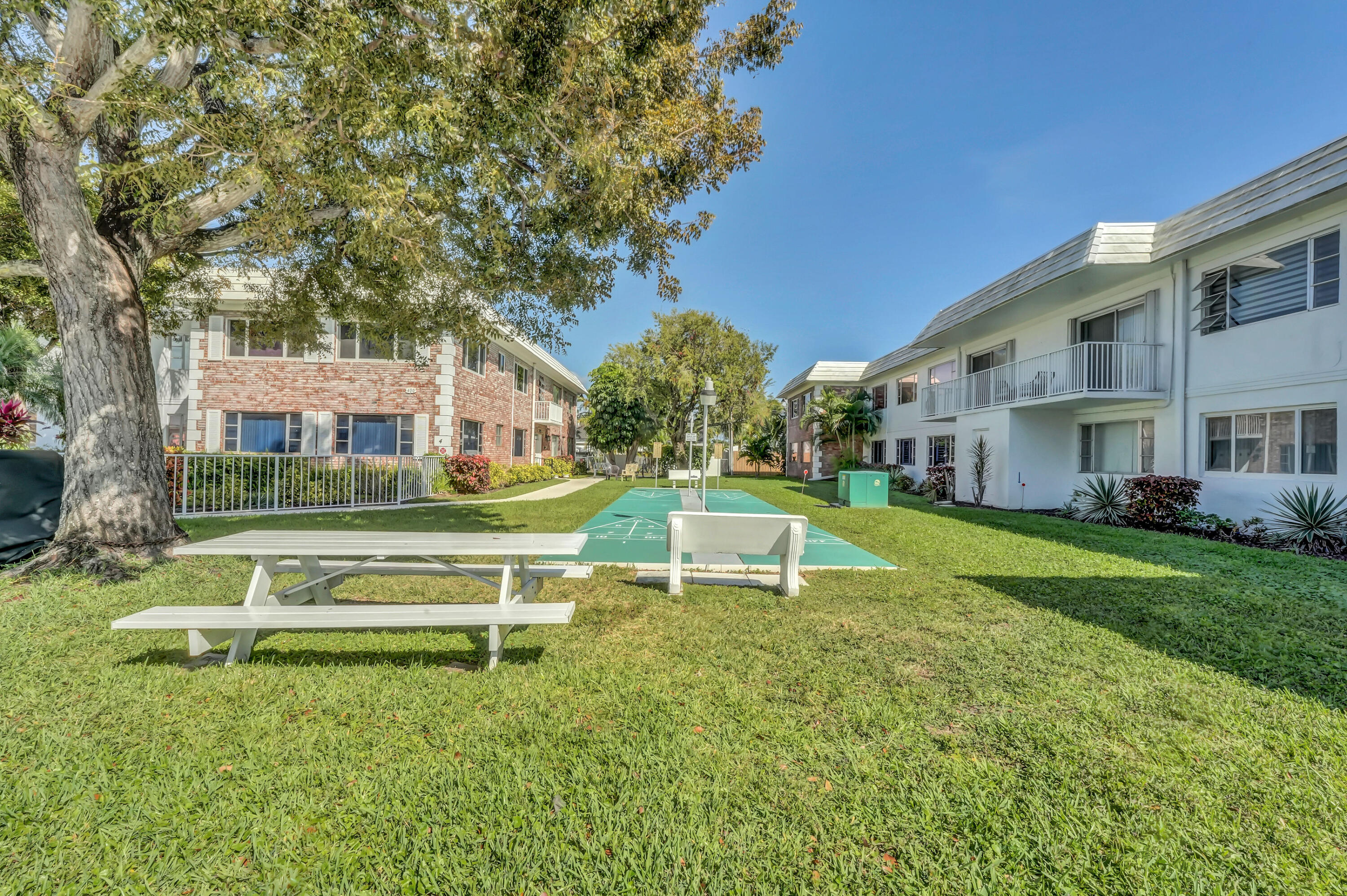 406 South Cypress Road, Unit 330 Pompano Beach, FL 33060 - Photo 34 of 38 a view of a house with a yard table and chairs