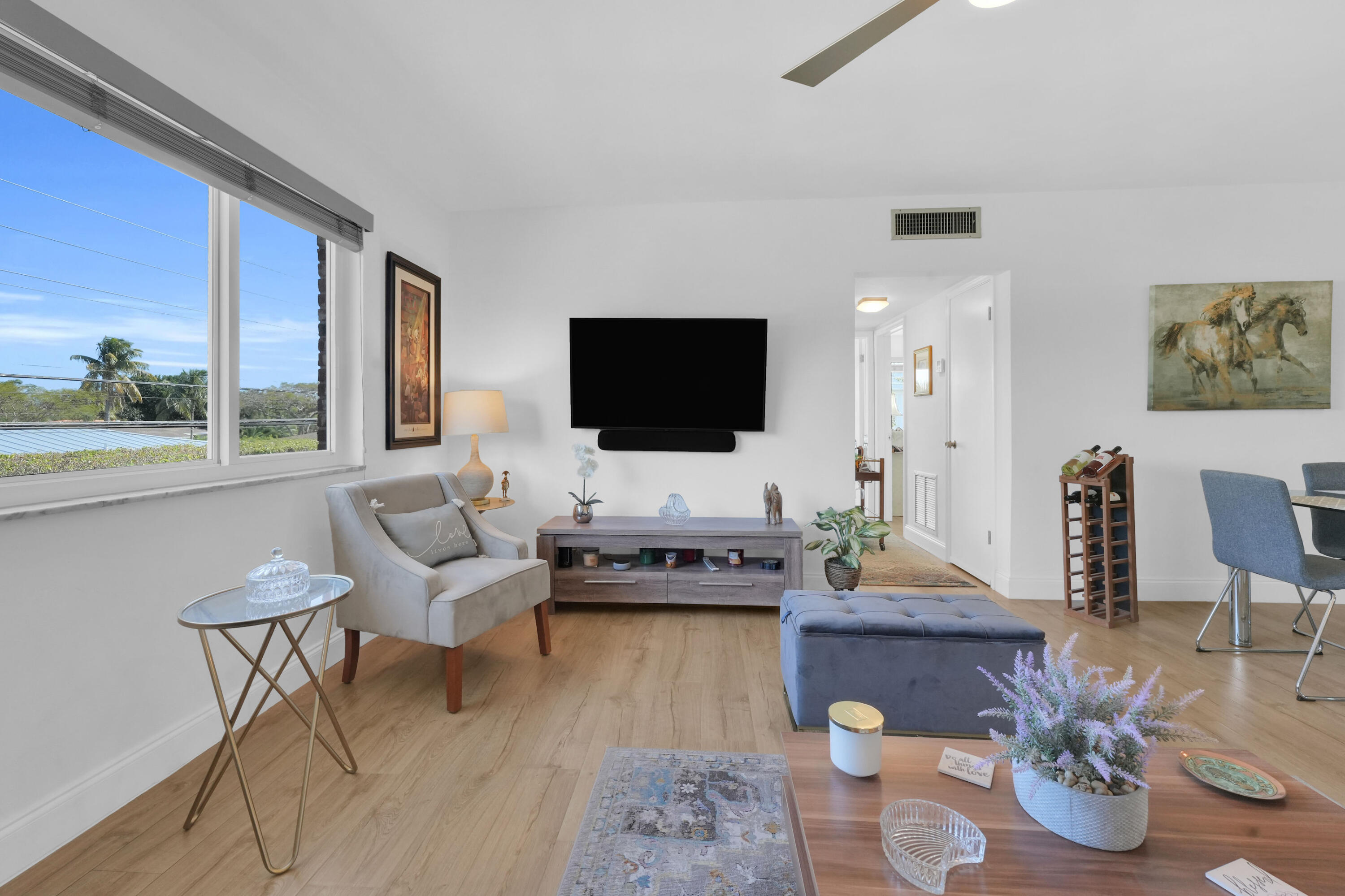 406 South Cypress Road, Unit 330 Pompano Beach, FL 33060 - Photo 6 of 38 a living room with furniture and a flat screen tv