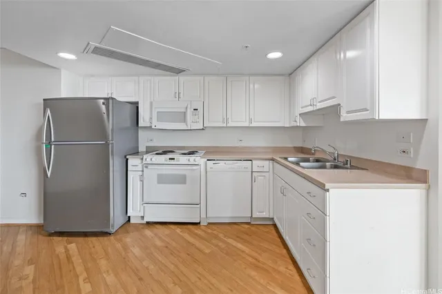 a kitchen with a white cabinets and white stainless steel appliances