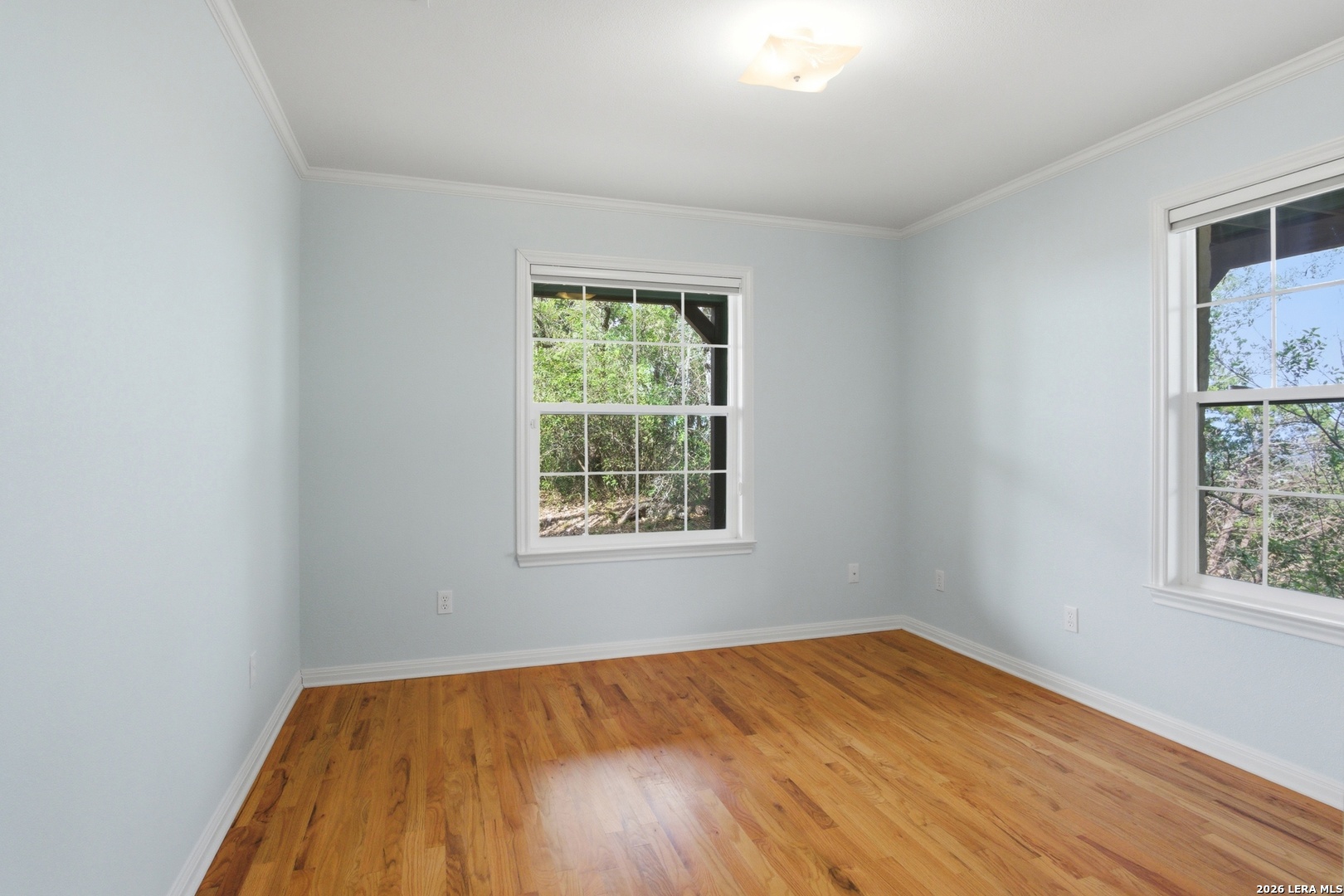 26 Seewald Road Boerne, TX 78006 - Photo 30 of 33 an empty room with wooden floor and windows