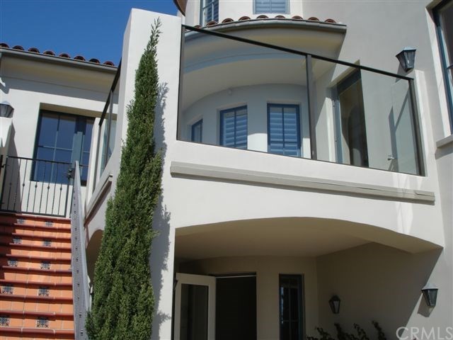 64 Sidra Cove Newport Coast, CA 92657 - Photo 15 of 16 a view of a house with a large window and potted plants