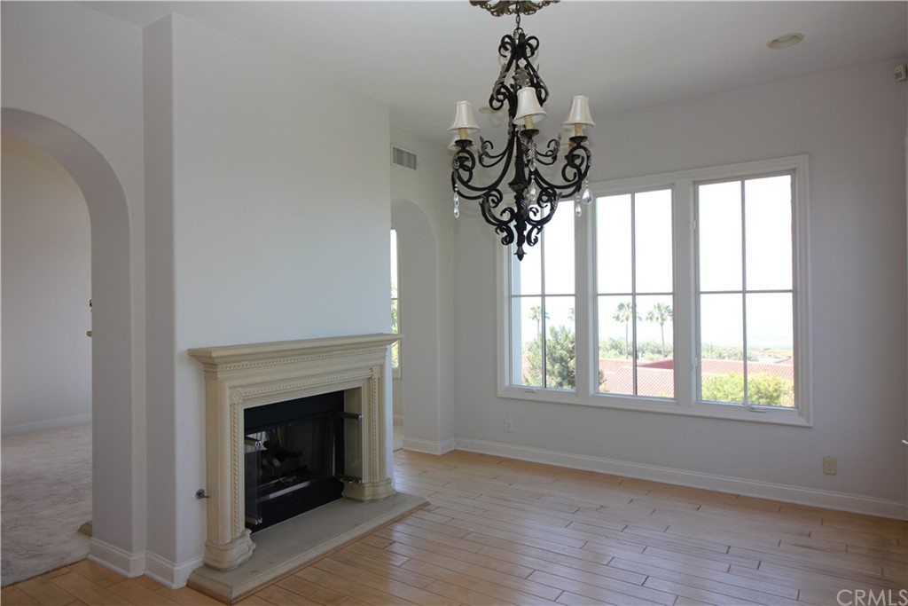 64 Sidra Cove Newport Coast, CA 92657 - Photo 4 of 16 a view of an empty room with a window and fireplace