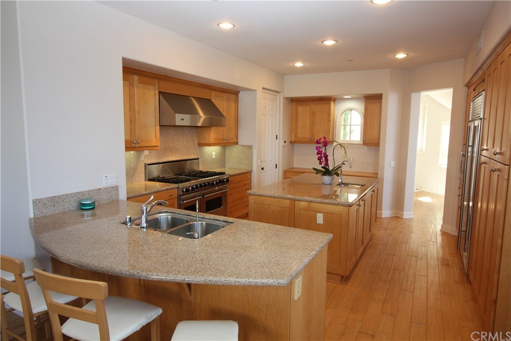 64 Sidra Cove Newport Coast, CA 92657 - Photo 7 of 16 a kitchen with a table chairs and refrigerator