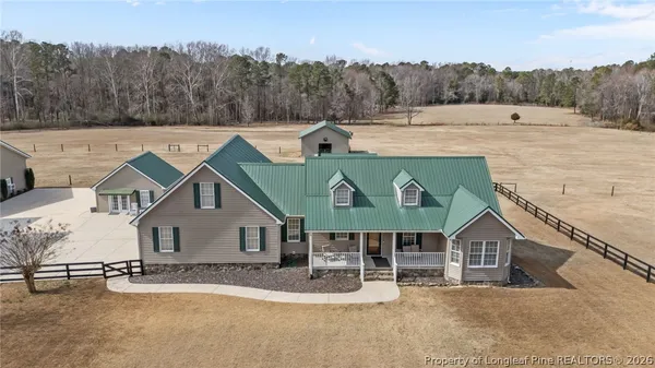 an aerial view of a house with a yard