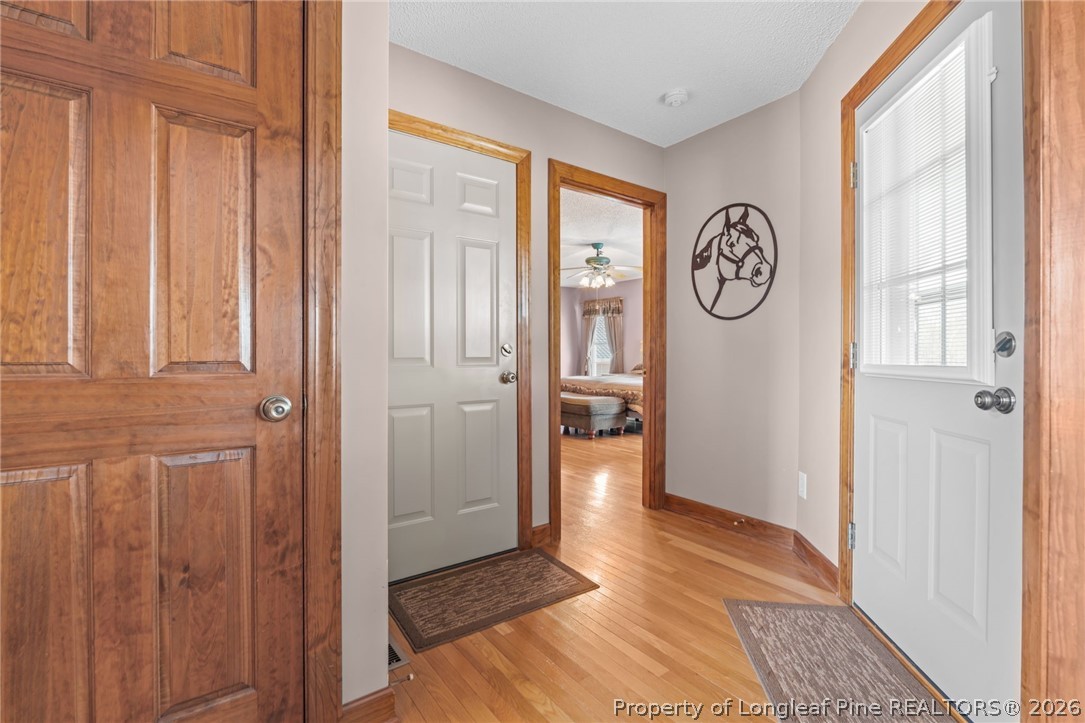 4240 Nicholson Road Cameron, NC 28326 - Photo 11 of 49 a view of a hallway with wooden floor and a window