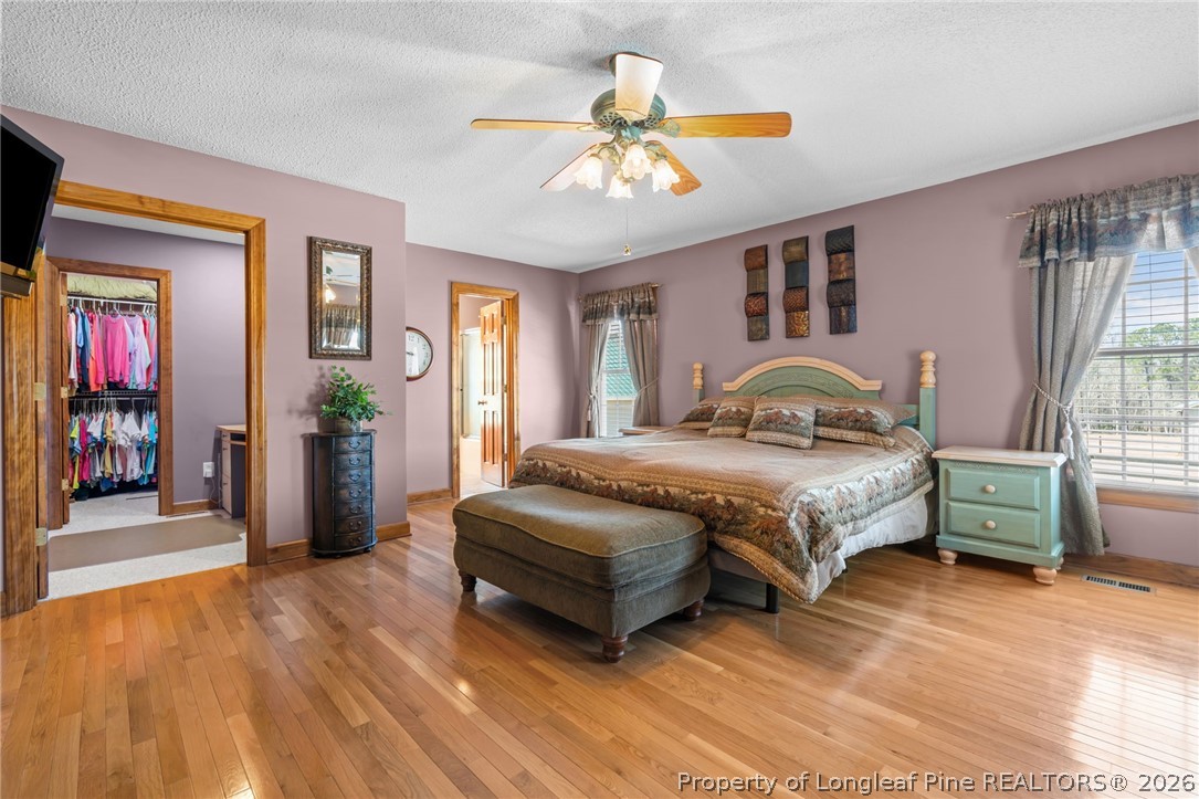 4240 Nicholson Road Cameron, NC 28326 - Photo 12 of 49 a bedroom with a bed and a chandelier