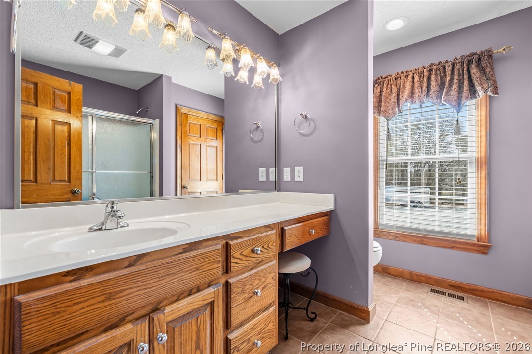 4240 Nicholson Road Cameron, NC 28326 - Photo 15 of 49 a bathroom with a sink a vanity and a large mirror
