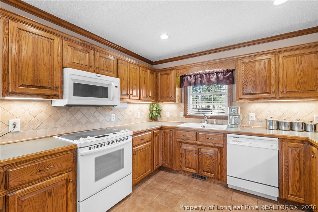 4240 Nicholson Road Cameron, NC 28326 - Photo 21 of 49 a kitchen with a sink stove and microwave