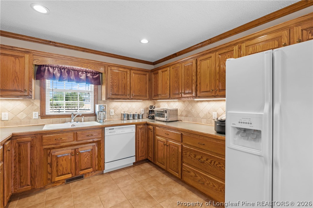 4240 Nicholson Road Cameron, NC 28326 - Photo 22 of 49 a kitchen with a sink stove and refrigerator