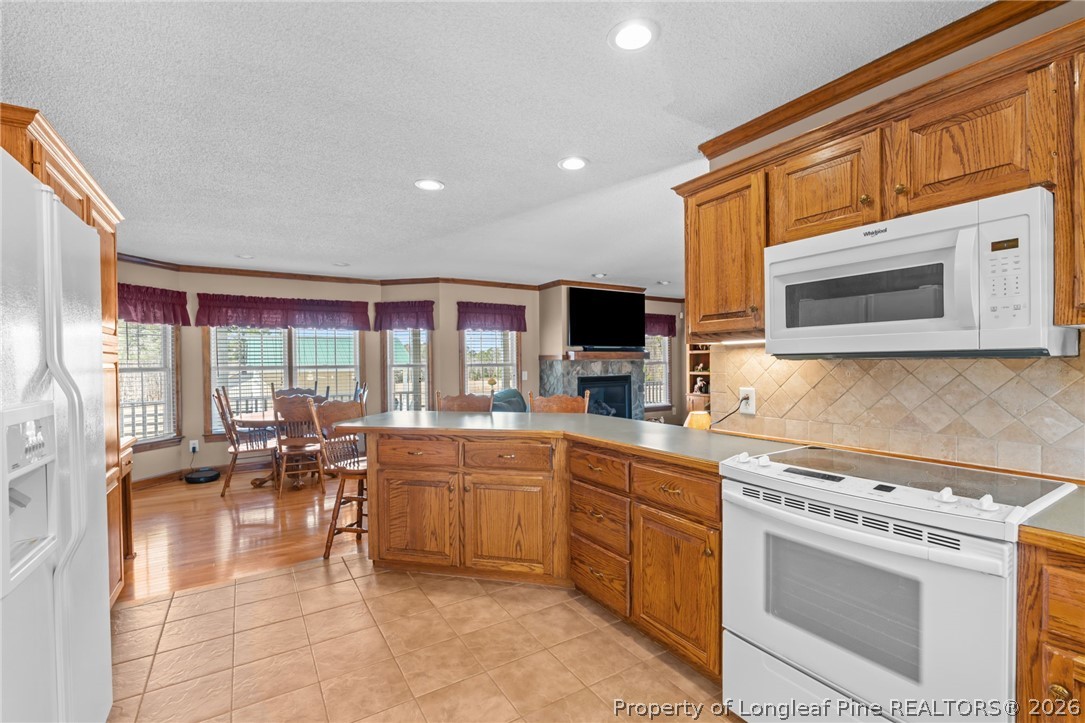 4240 Nicholson Road Cameron, NC 28326 - Photo 23 of 49 a kitchen with a stove a sink and a microwave