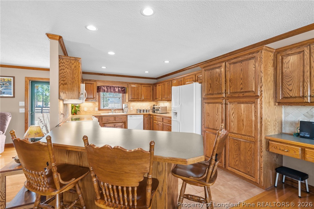 4240 Nicholson Road Cameron, NC 28326 - Photo 25 of 49 a large kitchen with dining table and stainless steel appliances