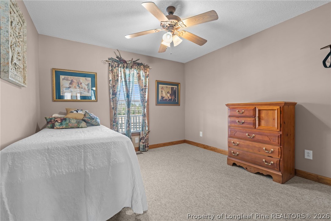 4240 Nicholson Road Cameron, NC 28326 - Photo 7 of 49 a bedroom with a bed and a cabinets