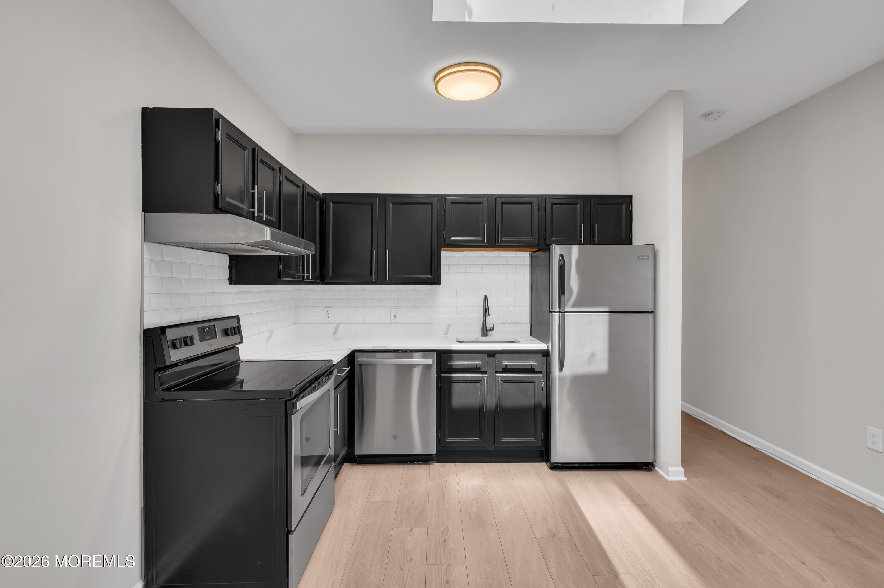 31-33 East Front Street, Unit 2 Red Bank, NJ 07701 - Photo 11 of 21 a kitchen with stainless steel appliances granite countertop a refrigerator stove top oven and sink