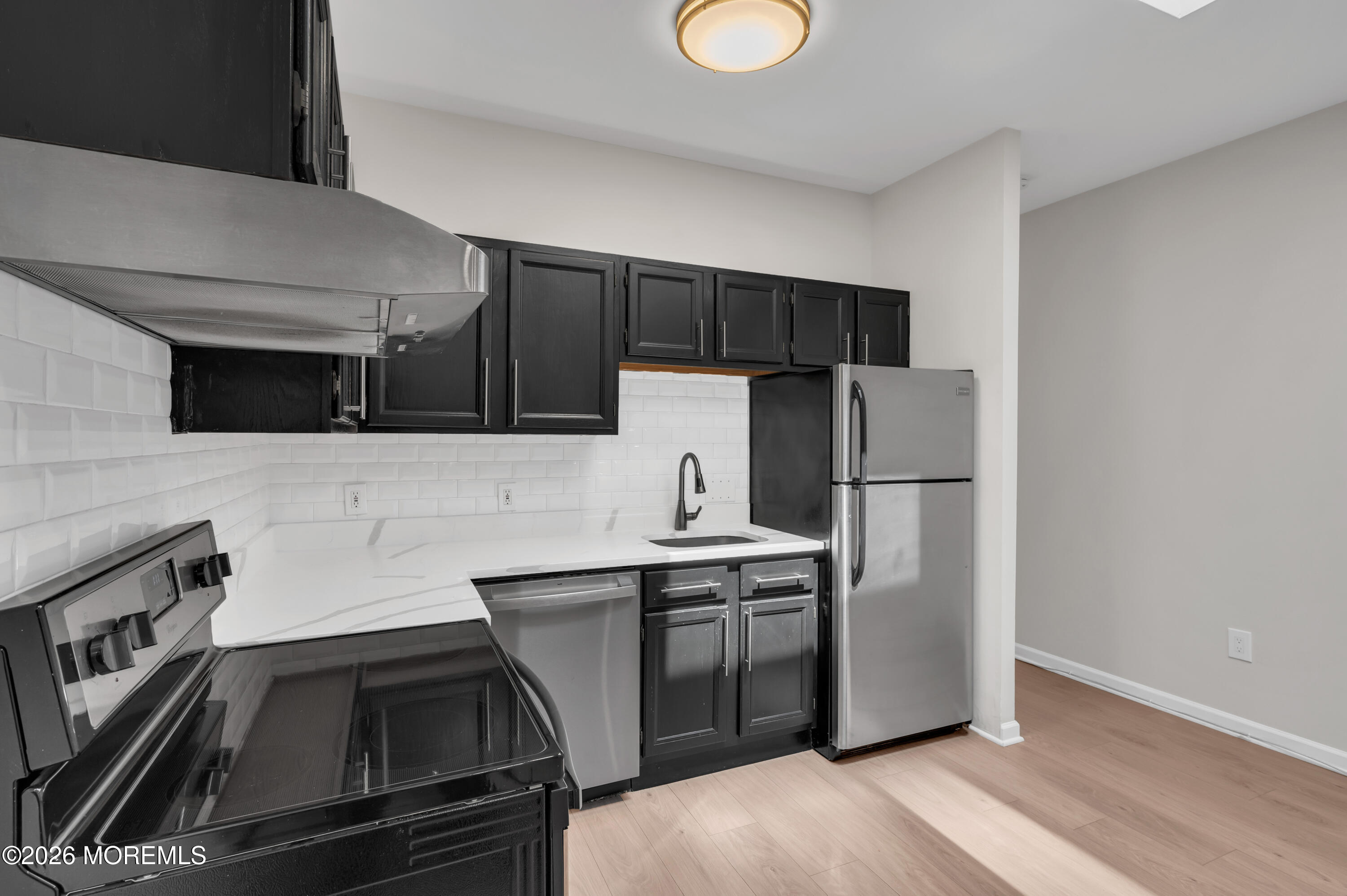 31-33 East Front Street, Unit 2 Red Bank, NJ 07701 - Photo 13 of 21 a kitchen with a sink and stainless steel appliances