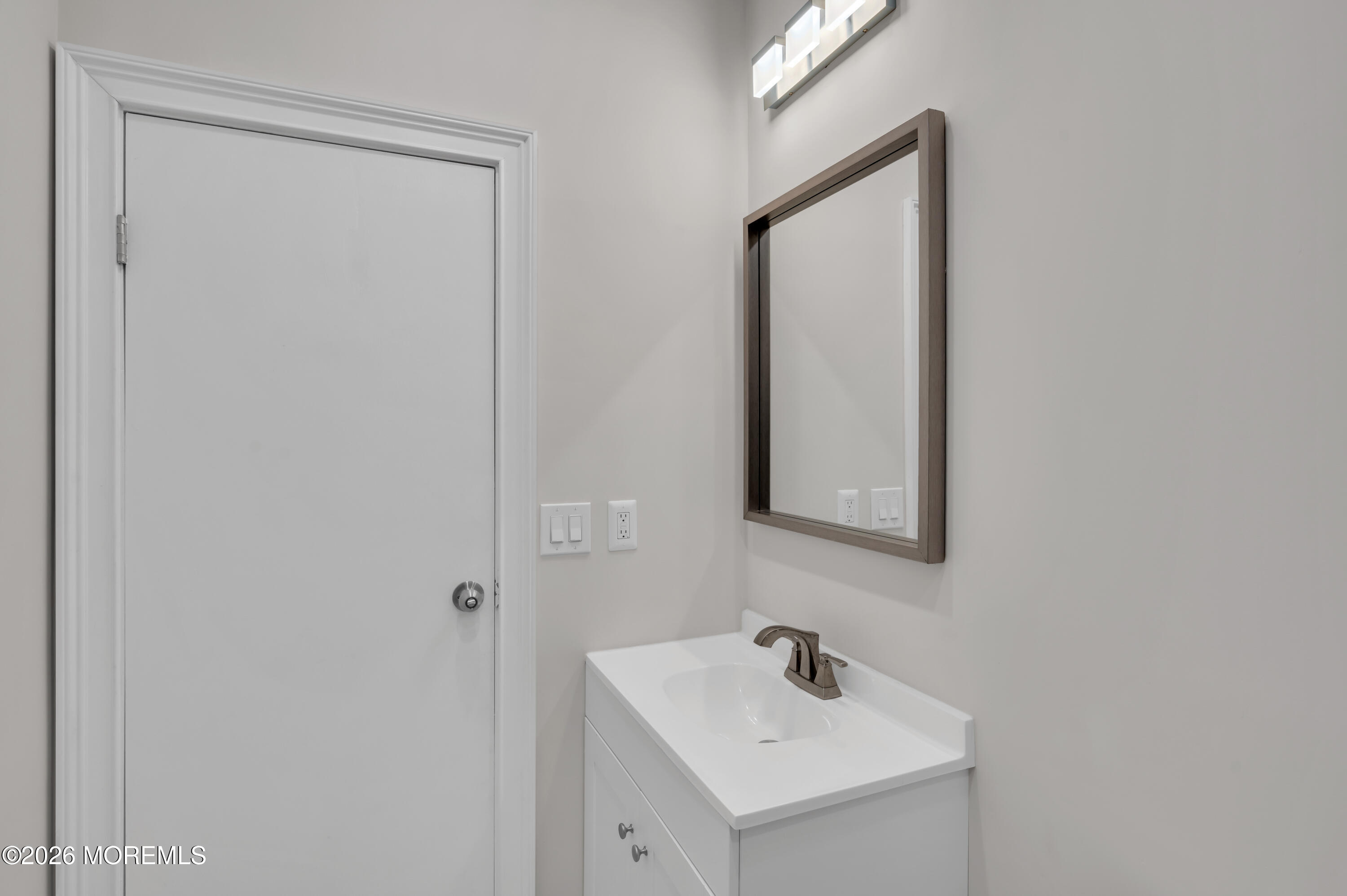 31-33 East Front Street, Unit 2 Red Bank, NJ 07701 - Photo 17 of 21 a bathroom with a sink and a mirror