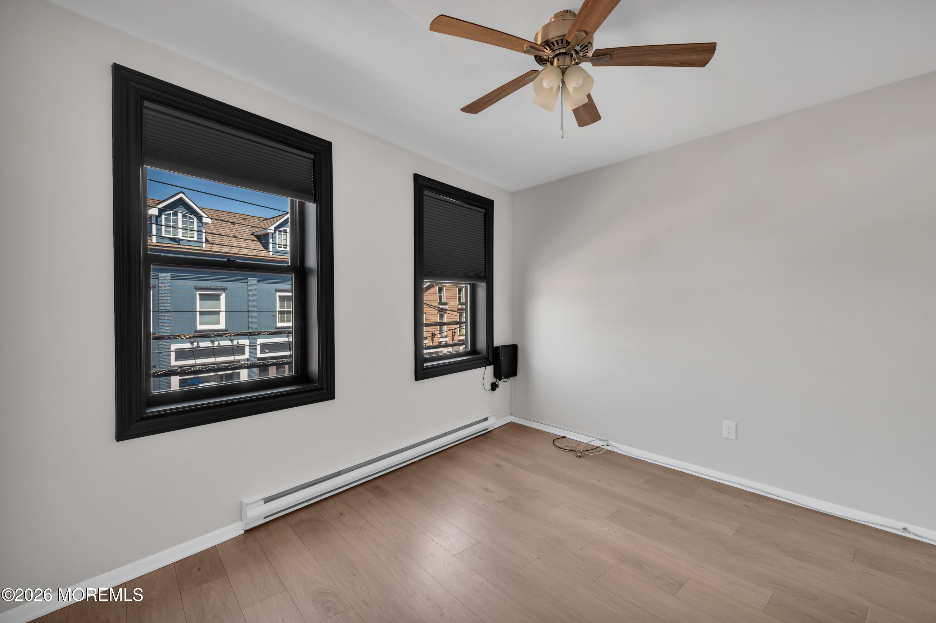 31-33 East Front Street, Unit 2 Red Bank, NJ 07701 - Photo 20 of 21 an empty room with a window and a ceiling fan