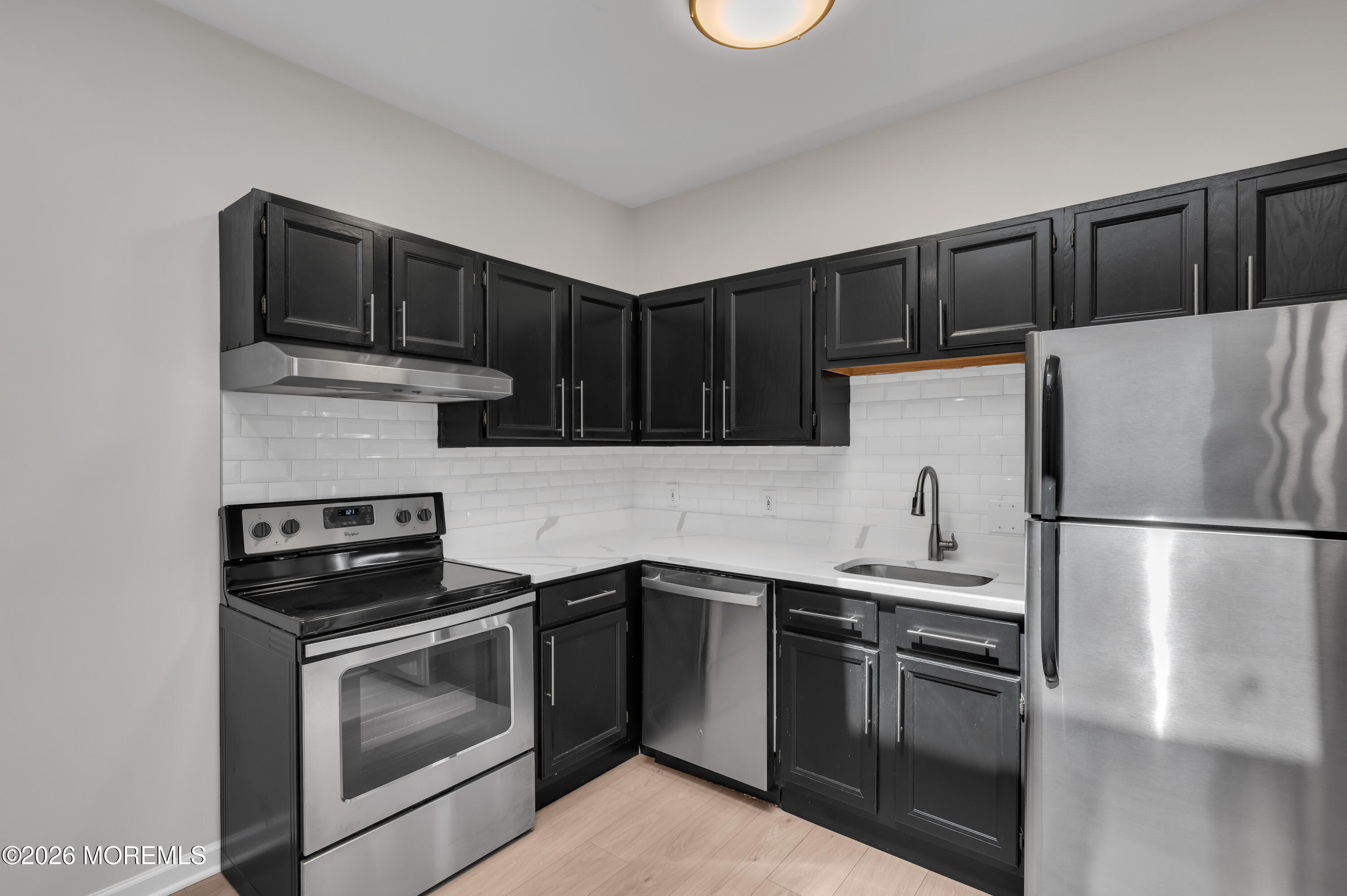 31-33 East Front Street, Unit 2 Red Bank, NJ 07701 - Photo 10 of 21 a kitchen with a refrigerator sink and microwave
