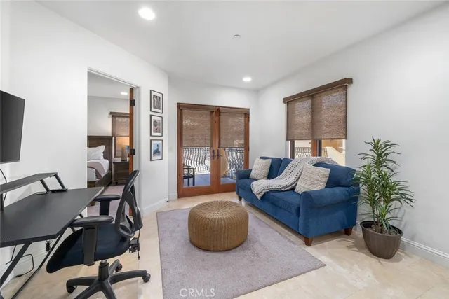 a living room with furniture potted plant and a flat screen tv