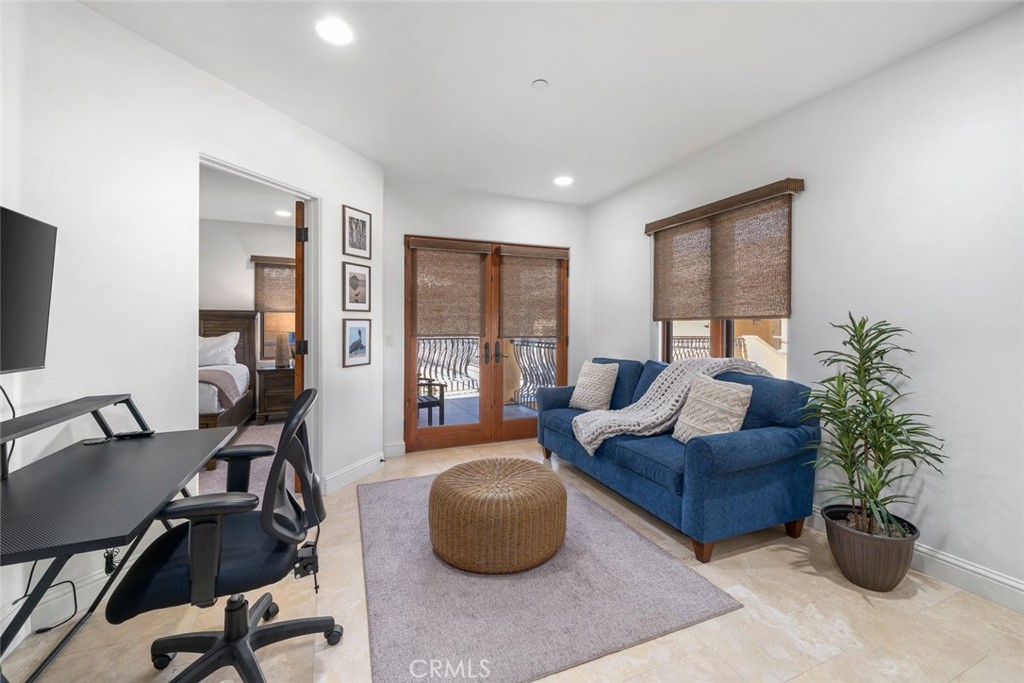 160 Hinds Avenue, Unit 202 Pismo Beach, CA 93449 - Photo 14 of 47 a living room with furniture potted plant and a flat screen tv