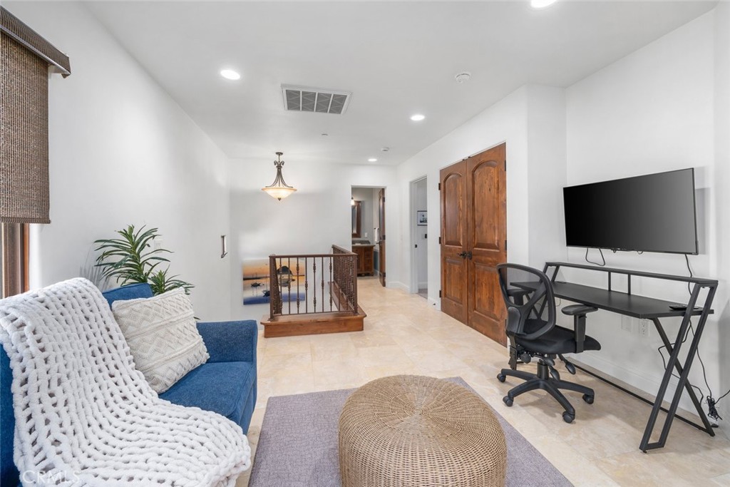 160 Hinds Avenue, Unit 202 Pismo Beach, CA 93449 - Photo 18 of 47 a living room with furniture and a flat screen tv