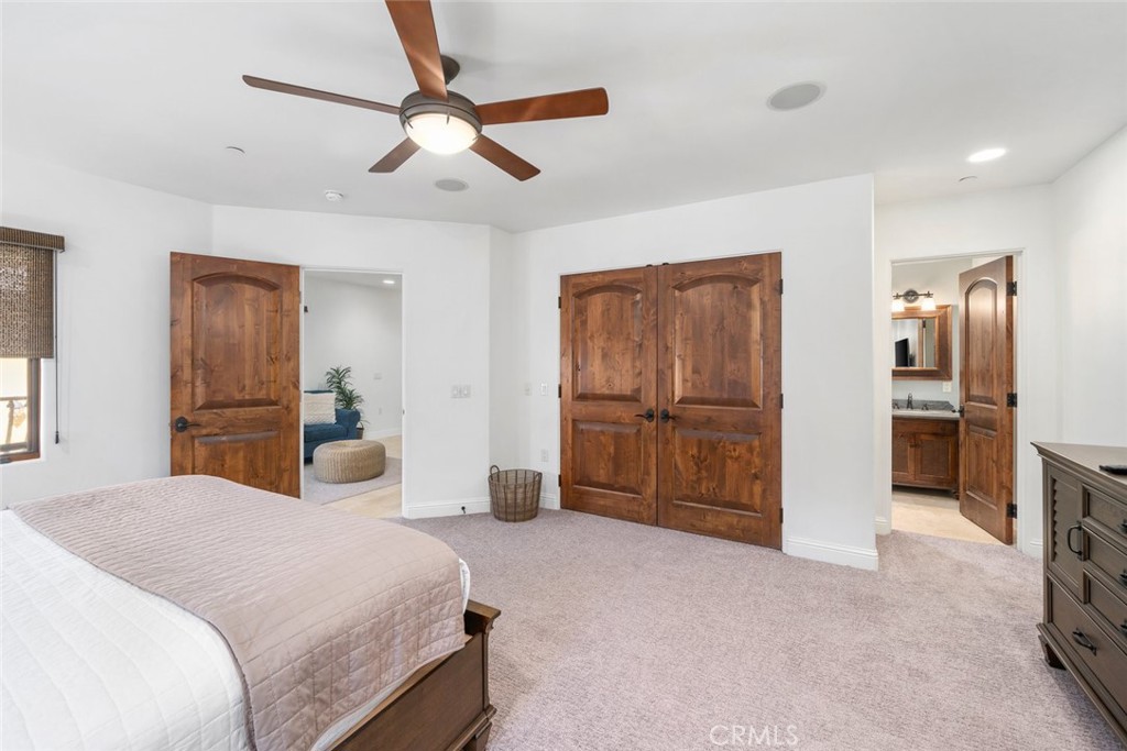 160 Hinds Avenue, Unit 202 Pismo Beach, CA 93449 - Photo 22 of 47 a bedroom with a bed and a television