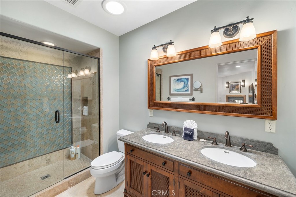 160 Hinds Avenue, Unit 202 Pismo Beach, CA 93449 - Photo 23 of 47 a bathroom with a granite countertop sink toilet and shower