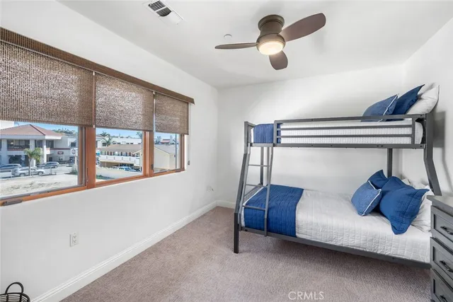 a bedroom with furniture and a large window