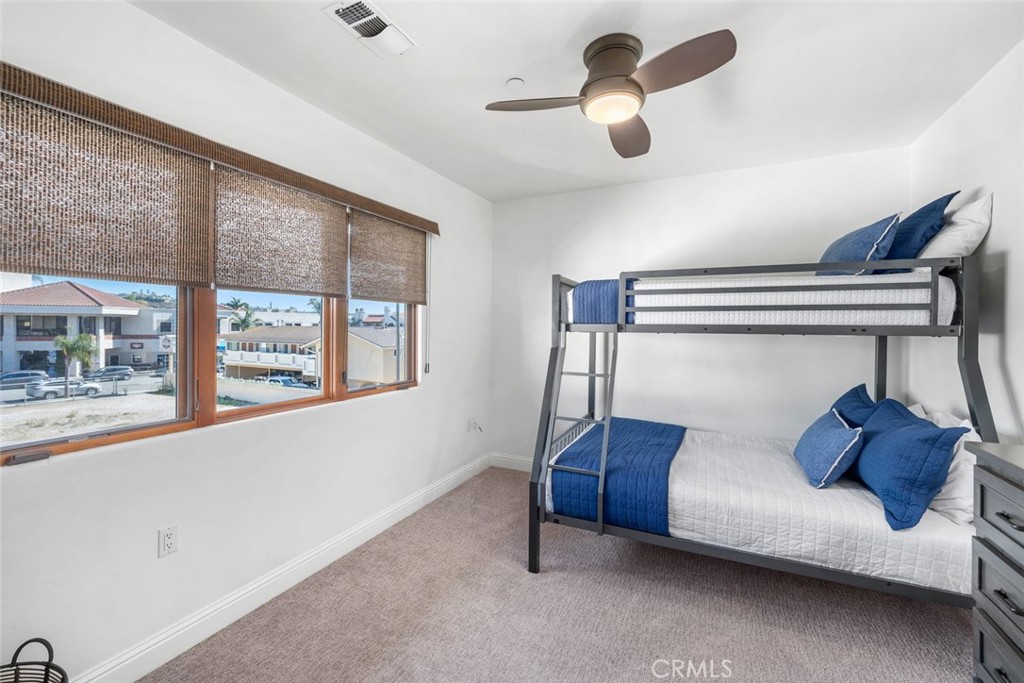 160 Hinds Avenue, Unit 202 Pismo Beach, CA 93449 - Photo 26 of 47 a bedroom with furniture and a large window