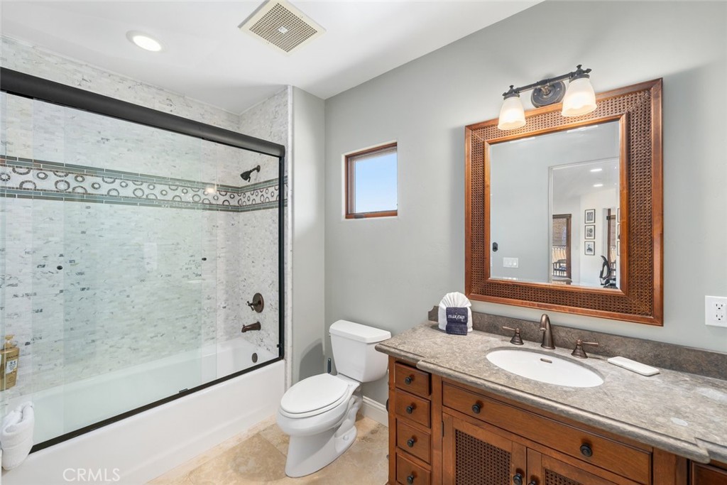160 Hinds Avenue, Unit 202 Pismo Beach, CA 93449 - Photo 28 of 47 a bathroom with a granite countertop sink mirror vanity and toilet