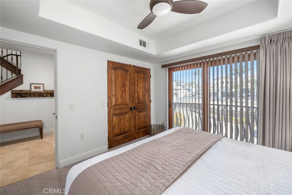 160 Hinds Avenue, Unit 202 Pismo Beach, CA 93449 - Photo 32 of 47 a bedroom with a bed and a large window