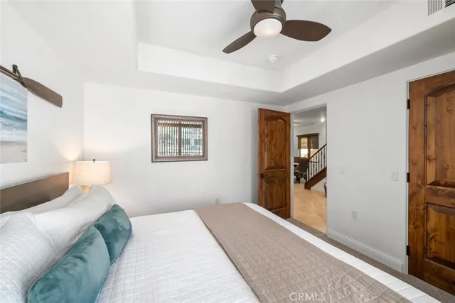 a bedroom with a bed and a large mirror