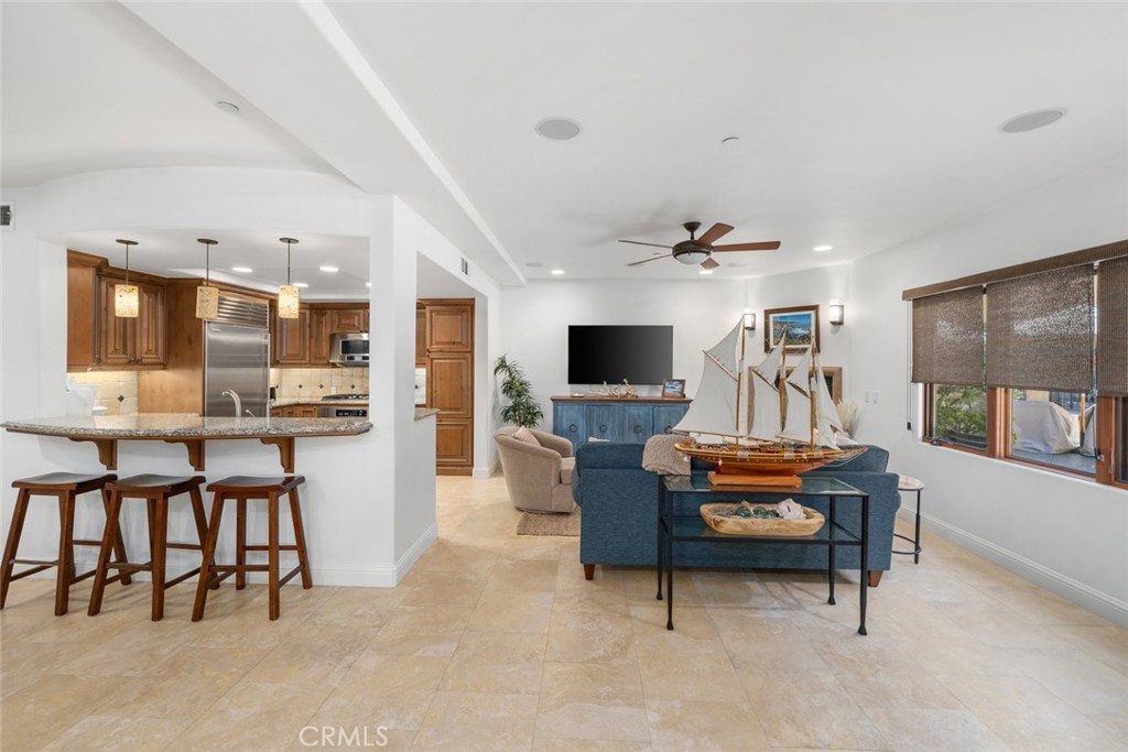 160 Hinds Avenue, Unit 202 Pismo Beach, CA 93449 - Photo 6 of 47 a living room with furniture and a flat screen tv