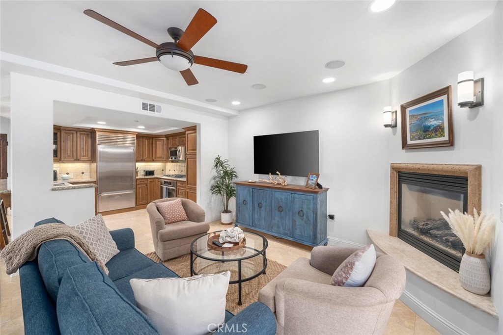160 Hinds Avenue, Unit 202 Pismo Beach, CA 93449 - Photo 7 of 47 a living room with furniture a flat screen tv and a fireplace