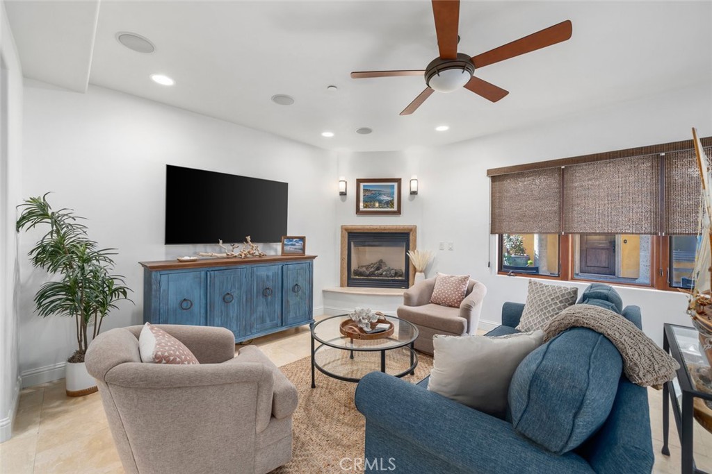 160 Hinds Avenue, Unit 202 Pismo Beach, CA 93449 - Photo 8 of 47 a living room with furniture and a flat screen tv