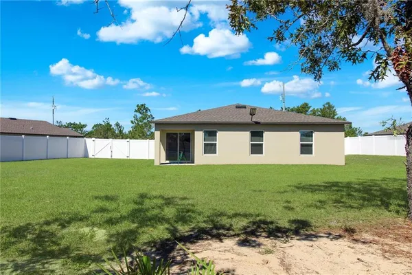 a view of a house with a backyard