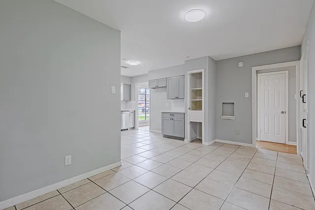 a view of kitchen with refrigerator and window