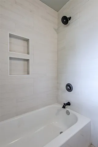 a bathroom with a tub and a shower