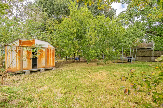 a view of backyard with swimming pool and seating space