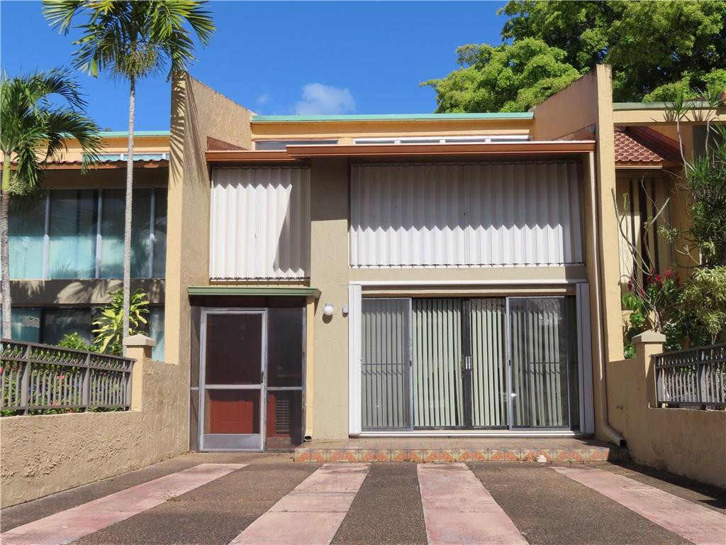 a view of a house with a window and plants