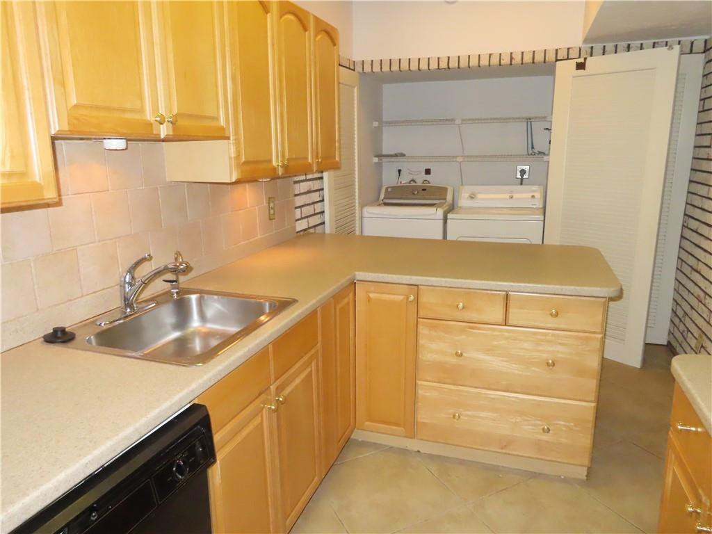 8801 Gatehouse Road, Unit 7 Plantation, FL 33324 - Photo 12 of 29 Kitchen showing washer & dryer in closet