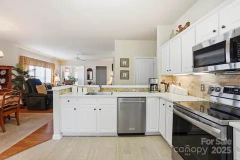 a kitchen with a sink stove and microwave